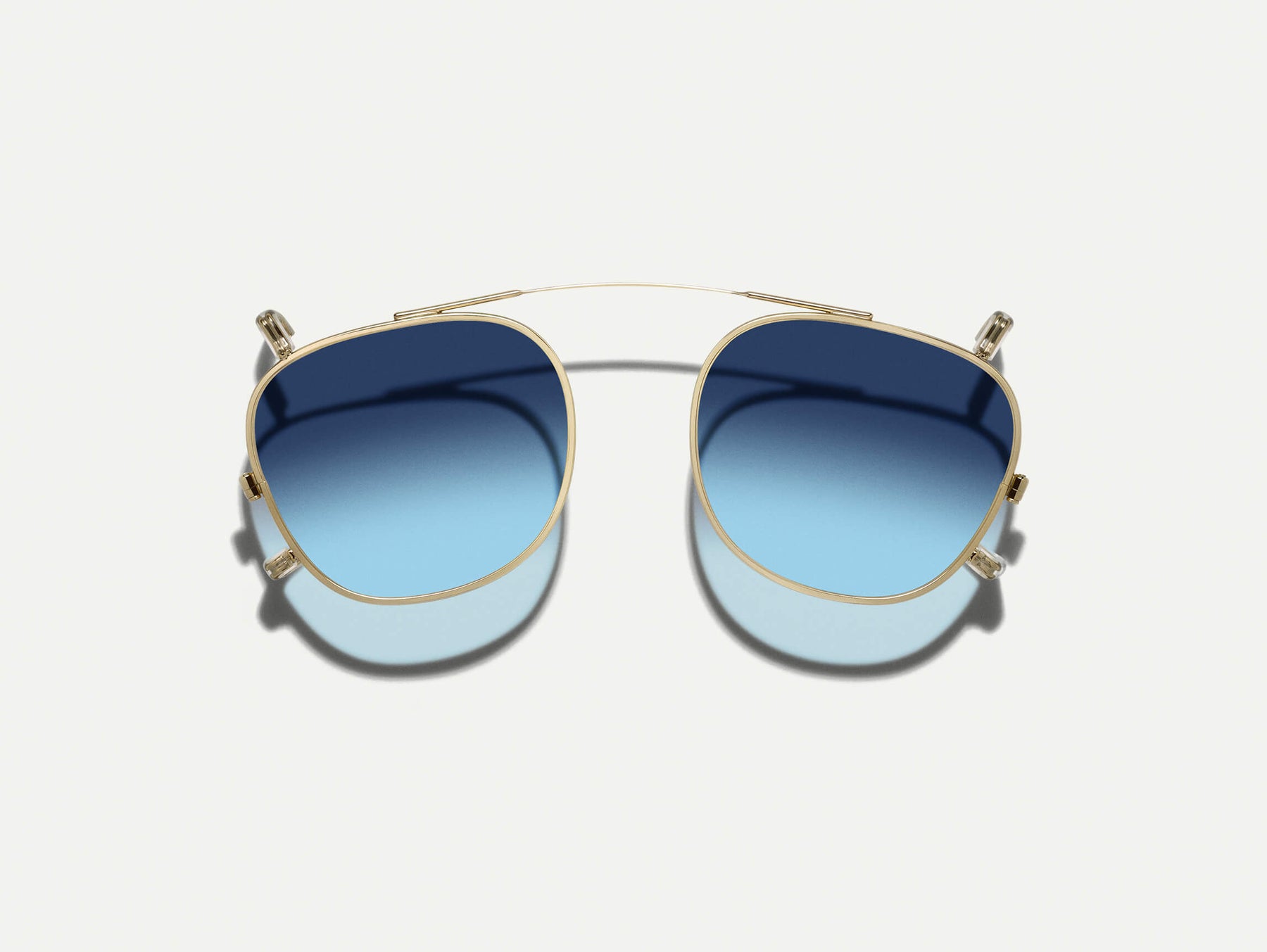 The DAHVEN CLIP in Gold with Denim Blue Tinted Lenses