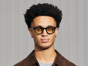 Model is wearing The DAHVEN in Black in size 47 with Limelight Tinted Lenses