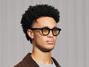 Model is wearing The DAHVEN in Black in size 47 with Limelight Tinted Lenses