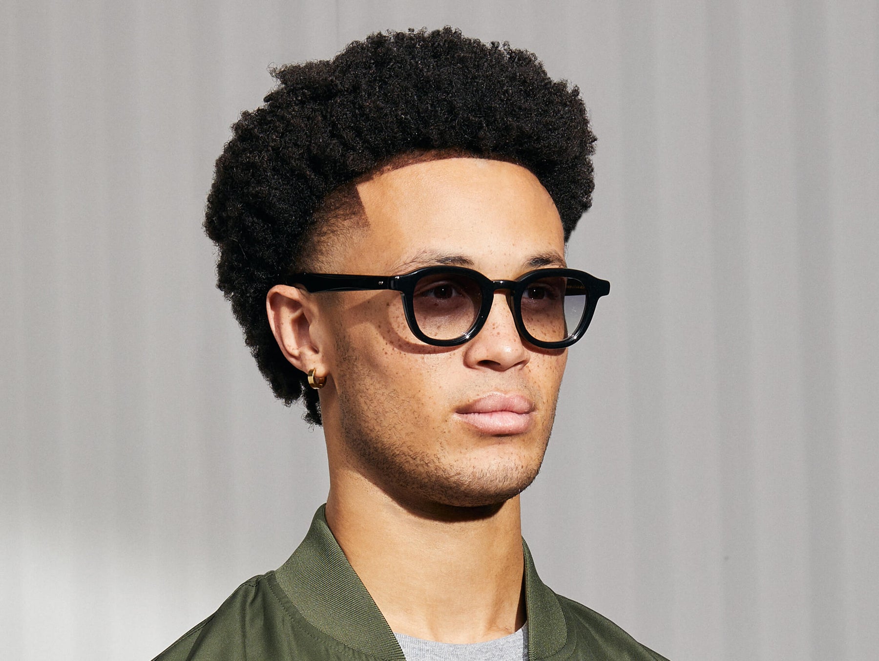 Model is wearing The DAHVEN in Black in size 47 with American Grey Fade Tinted Lenses