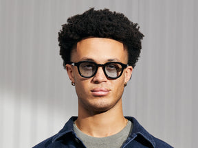 Model is wearing The DAHVEN in Black in size 47 with Bel Air Blue Tinted Lenses