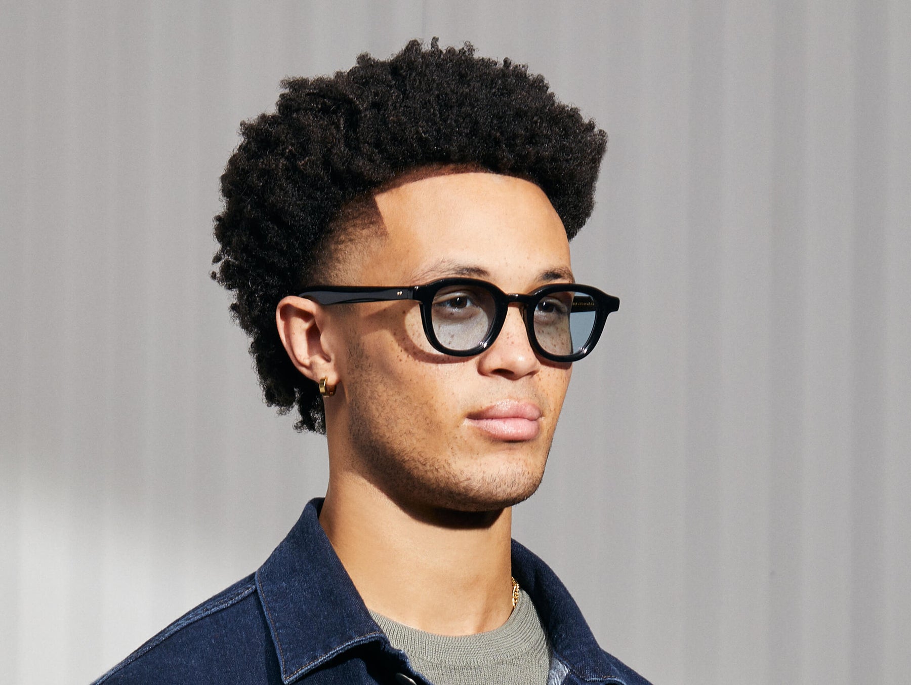Model is wearing The DAHVEN in Black in size 47 with Bel Air Blue Tinted Lenses