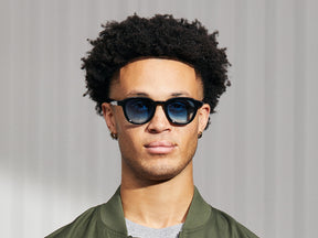 Model is wearing The DAHVEN in Black in size 47 with Broadway Blue Fade Tinted Lenses