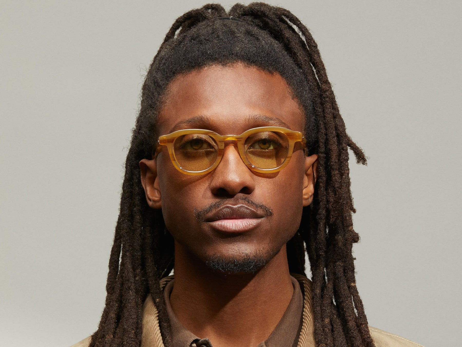 Model is wearing The DAHVEN in Blonde in size 44 with GREEN+ Tinted Lenses