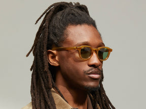 Model is wearing The DAHVEN in Blonde in size 44 with GREEN+ Tinted Lenses