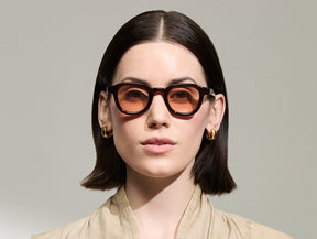Model is wearing The DAHVEN in Burgundy in size 44 with New York Rose Tinted Lenses