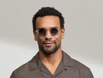 Model is wearing The DIBBIK SUN in size 45 in Flesh with Denim Blue Tinted Lenses