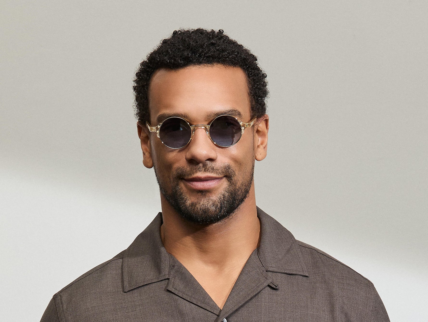 Model is wearing The DIBBIK SUN in size 45 in Flesh with Denim Blue Tinted Lenses