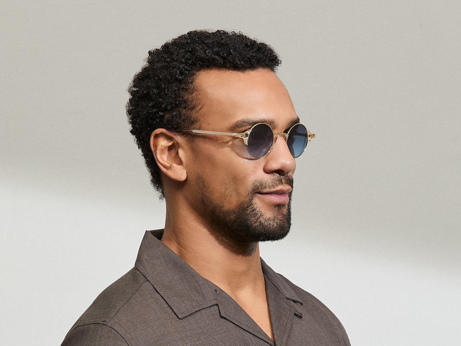 Model is wearing The DIBBIK SUN in size 45 in Flesh with Denim Blue Tinted Lenses