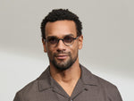 Model is wearing The DIBBIK SUN in size 45 in Smoke with American Grey Fade Tinted Lenses