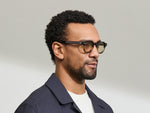 Model is wearing The DOLT in Grey-Brown Fade in size 46 with AMBER+ Lenses