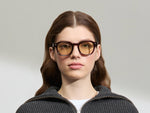 Model is wearing The DOLT in Burgundy in size 49 with AMBER+ Lenses