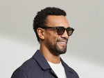 Model is wearing The DOLT in Dark Green in size 46 with AMBER+ Lenses
