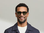 Model is wearing The DOLT in Dark Green in size 46 with GREEN+ Lenses