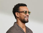 Model is wearing The DOLT in Flesh/Tortoise in size 46 with GREEN+ Lenses