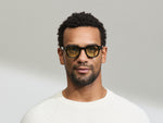 Model is wearing The DOLT in Black in size 46 with GREEN+ Lenses