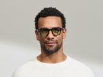 Model is wearing The DOLT in Navy in size 46 with GREEN+ Lenses