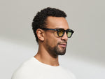 Model is wearing The DOLT in Navy in size 46 with GREEN+ Lenses