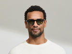 Model is wearing The DOLT in Navy in size 46 with GREEN+ Lenses