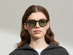 Model is wearing The DOLT in Burgundy in size 49 with GREEN+ Lenses