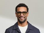 Model is wearing The DOLT in Dark Green in size 46 with GREEN+ Lenses