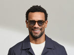 Model is wearing The DOLT SUN in size 46 in Cognac with Mineral Blue Tinted Lenses