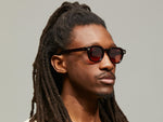 Model is wearing The DOLT SUN in Burgundy in size 46 with Cabernet Tinted Lenses