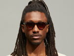 Model is wearing The DOLT SUN in Burgundy in size 46 with Cabernet Tinted Lenses