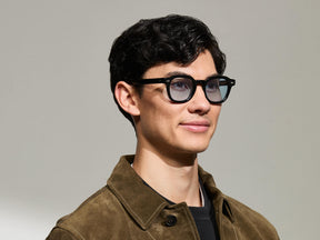 The Model is wearing The DOLT in Black in size 46 with Bel Air Blue Tinted Lenses