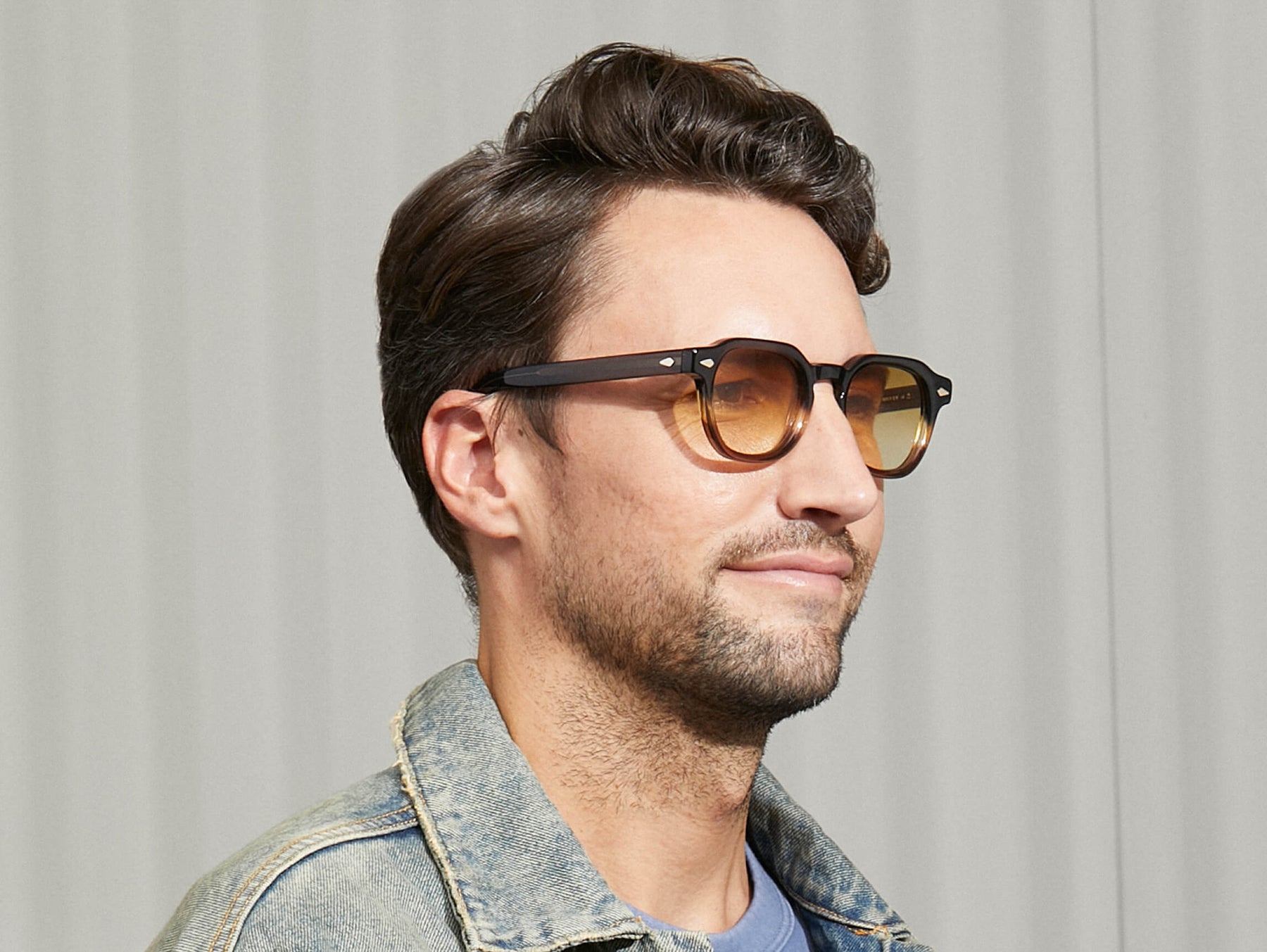 Model is wearing The DOLT SUN in Grey-Brown Fade in size 49 with Chestnut Fade Tinted Lenses