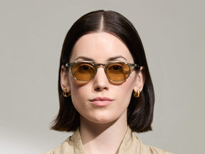 Model is wearing The FRANKIE CLIP in Gold in size 48 with Amber Tinted Lenses