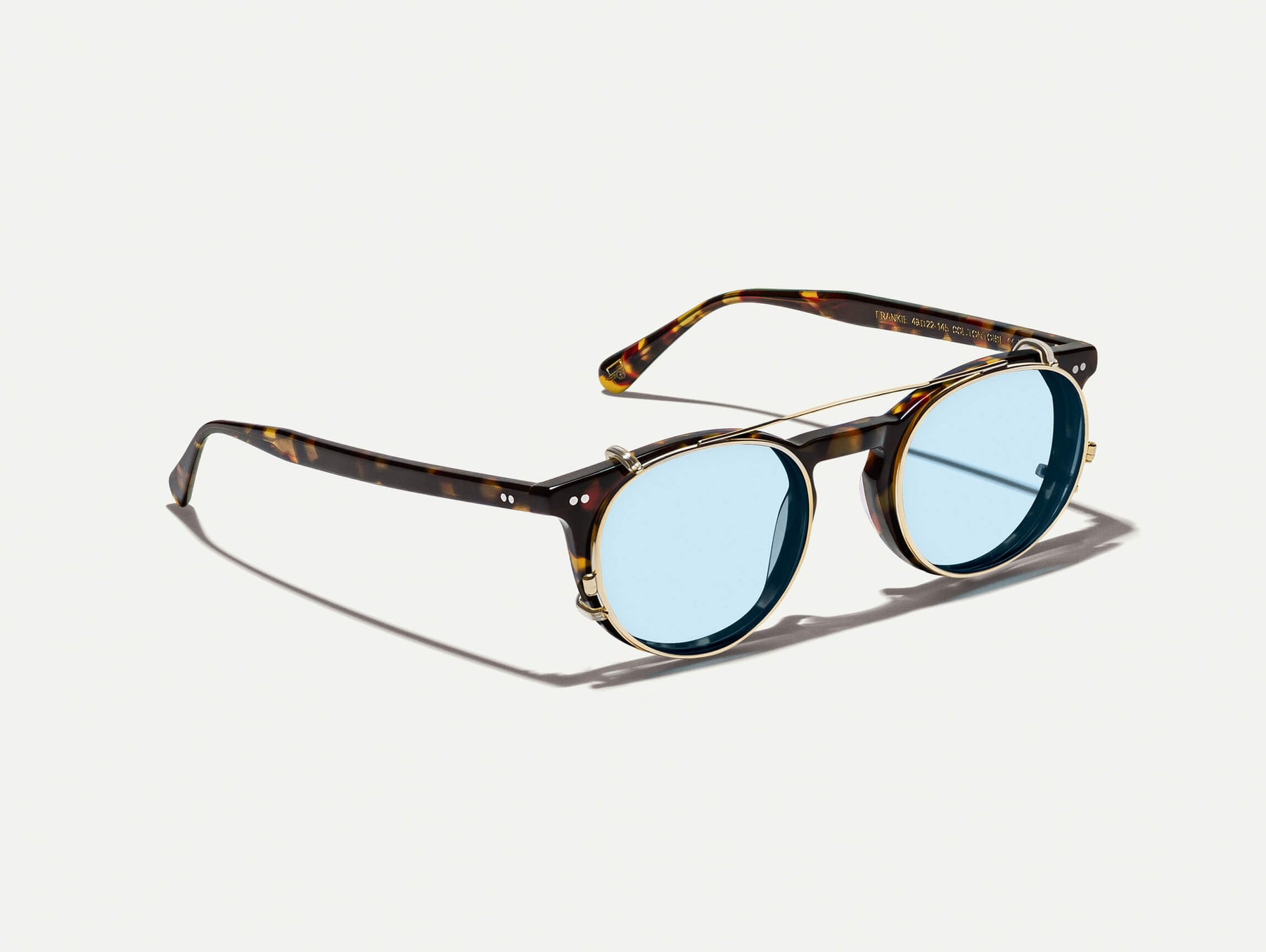 The FRANKIE CLIP  in Gold with Bel Air Blue Tinted Lenses