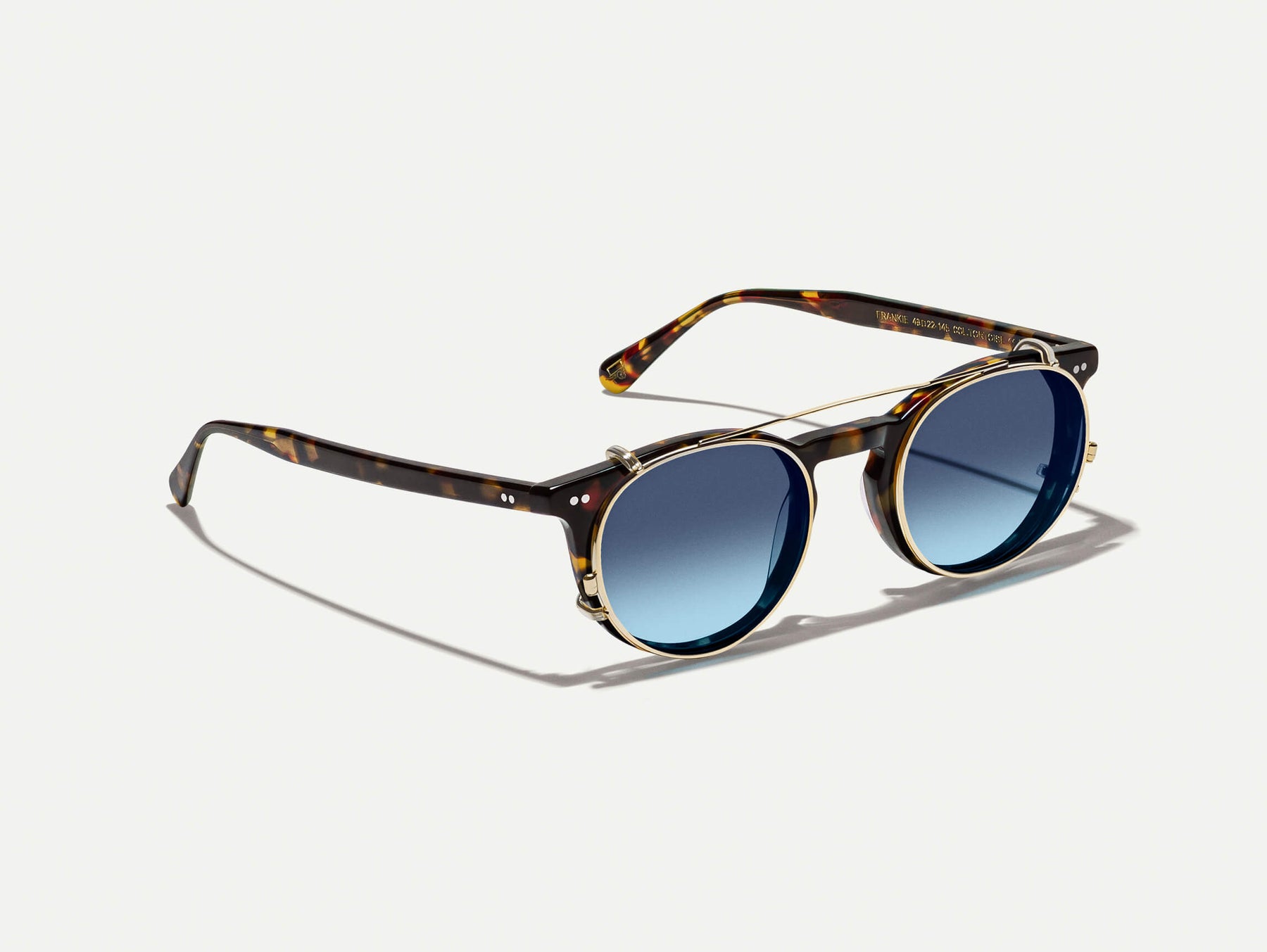 The FRANKIE CLIP  in Gold with Denim Blue Tinted Lenses
