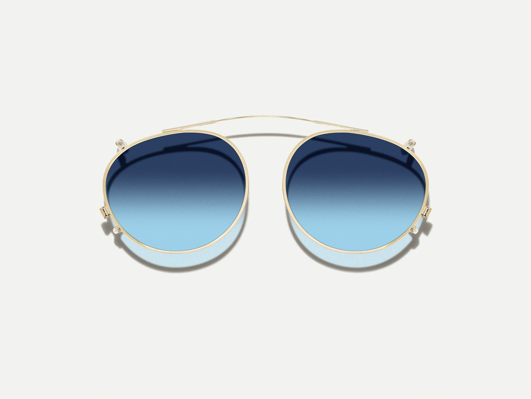 The FRANKIE CLIP  in Gold with Denim Blue Tinted Lenses
