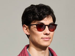 Model is wearing The FRANKIE SUN in Burgundy in size 51 with Cabernet Tinted Lenses