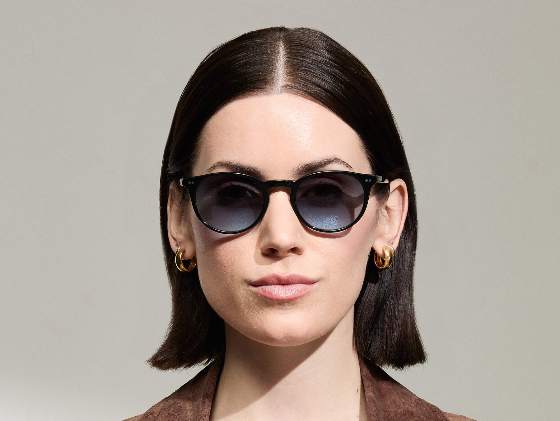 Model is wearing The FRANKIE SUN in Black in size 51 with Denim Blue Tinted Lenses
