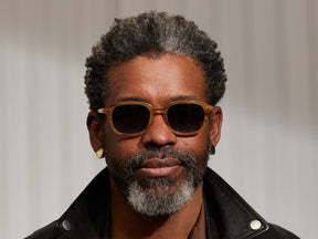 Model is wearing The GATKES SUN in Blonde in size 52 with Denim Blue Tinted Lenses