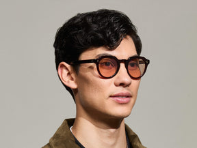 Model is wearing The GAVOLT SUN in Burgundy in size 48 with New York Rose Tinted Lenses