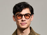 Model is wearing The GAVOLT SUN in Burgundy in size 48 with New York Rose Tinted Lenses