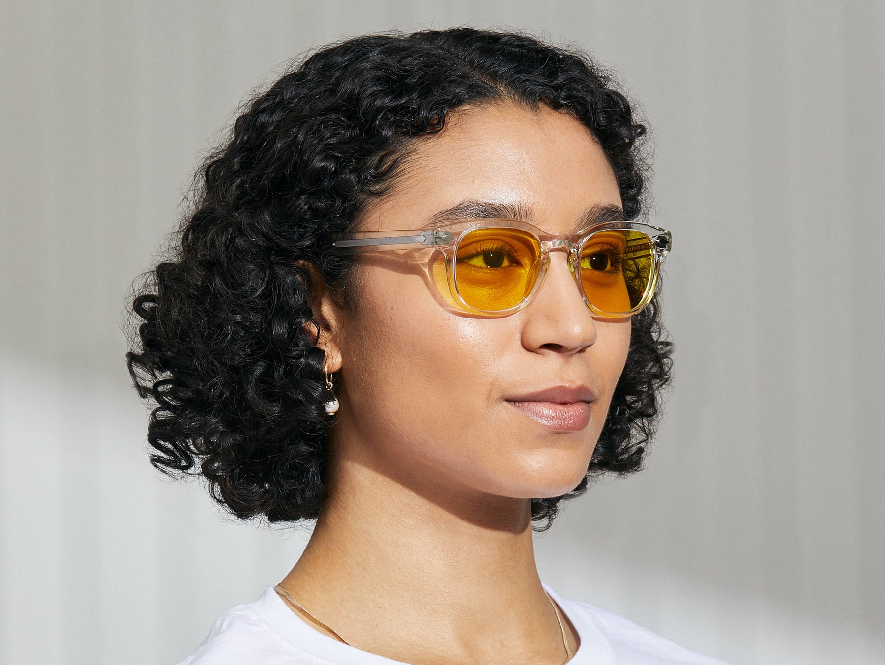 Model is wearing The GELT in Crystal in size 49 with Mellow Yellow Tinted Lenses