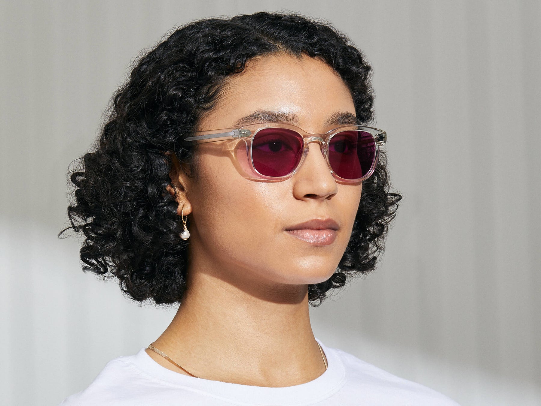 Model is wearing The GELT in Crystal in size 49 with Purple Nurple Tinted Lenses