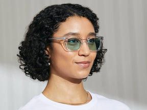 Model is wearing The GROBER in Crystal in size 48 with Turquoise Tinted Lenses