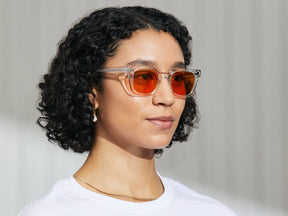 Model is wearing The GROBER in Crystal in size 48 with Woodstock Orange Tinted Lenses