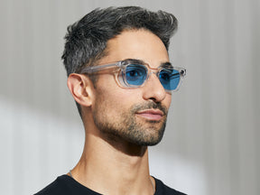 Model is wearing The GROBER in Crystal in size 45 with Celebrity Blue Tinted Lenses