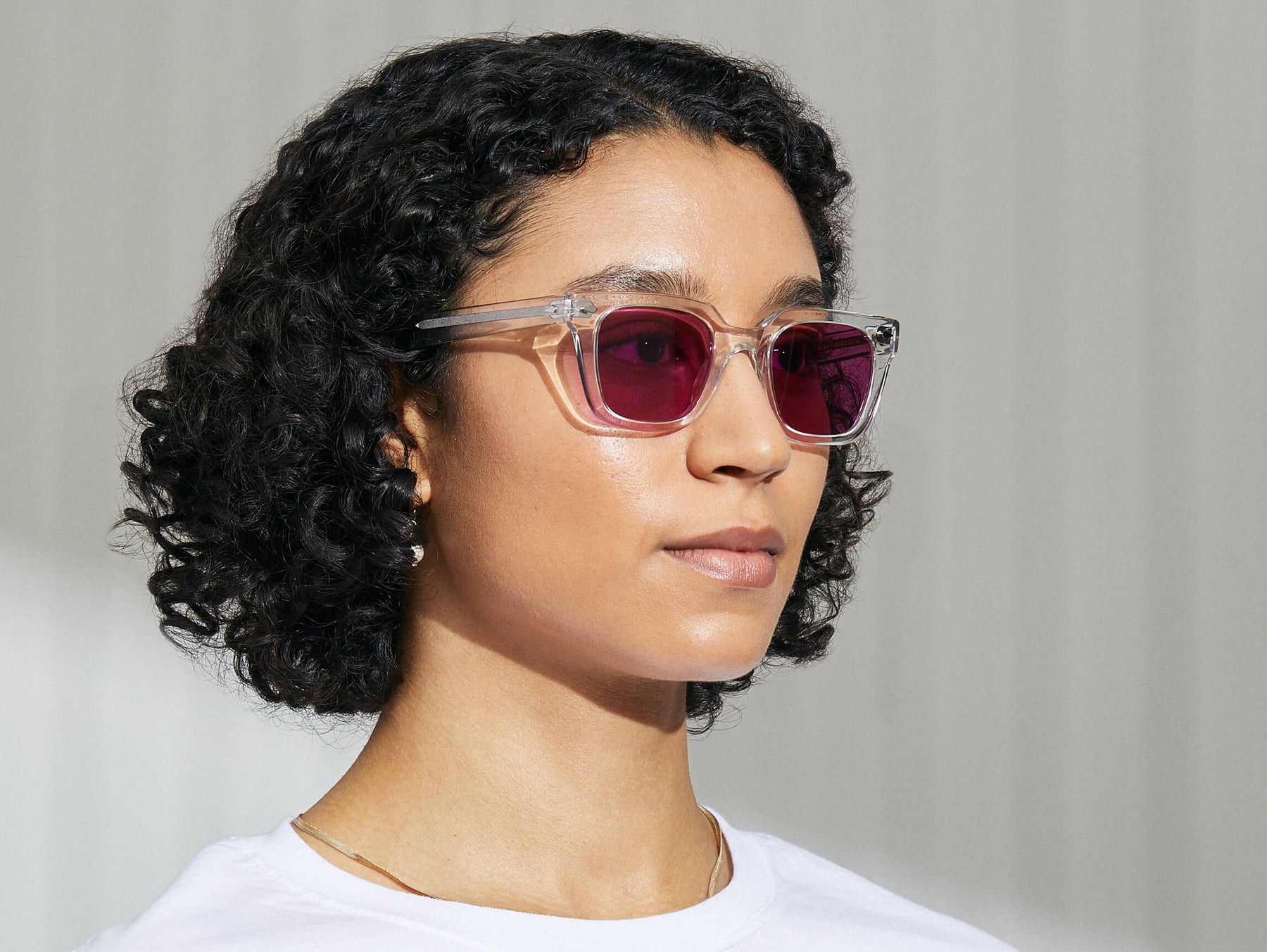 Model is wearing The GROBER in Crystal in size 48 with Purple Nurple Tinted Lenses