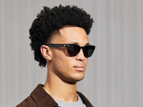 Model is wearing The HAZEN SUN in Black in size 50 with G-15 Glass Lenses