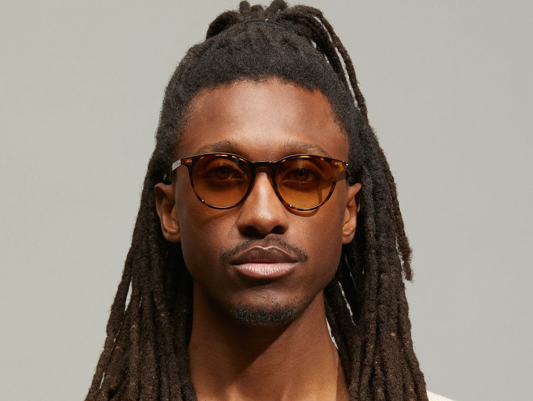Model is wearing The JARED SUN in size 50 in Spot Tortoise with Chestnut Fade Tinted Lenses