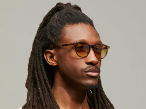Model is wearing The JARED SUN in size 50 in Spot Tortoise with Chestnut Fade Tinted Lenses
