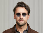 Model is wearing The KUGEL SUN in Cinnamon in size 49 with Denim Blue Tinted Lenses