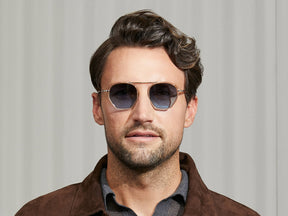 Model is wearing The KUGEL SUN in Cinnamon in size 49 with Denim Blue Tinted Lenses